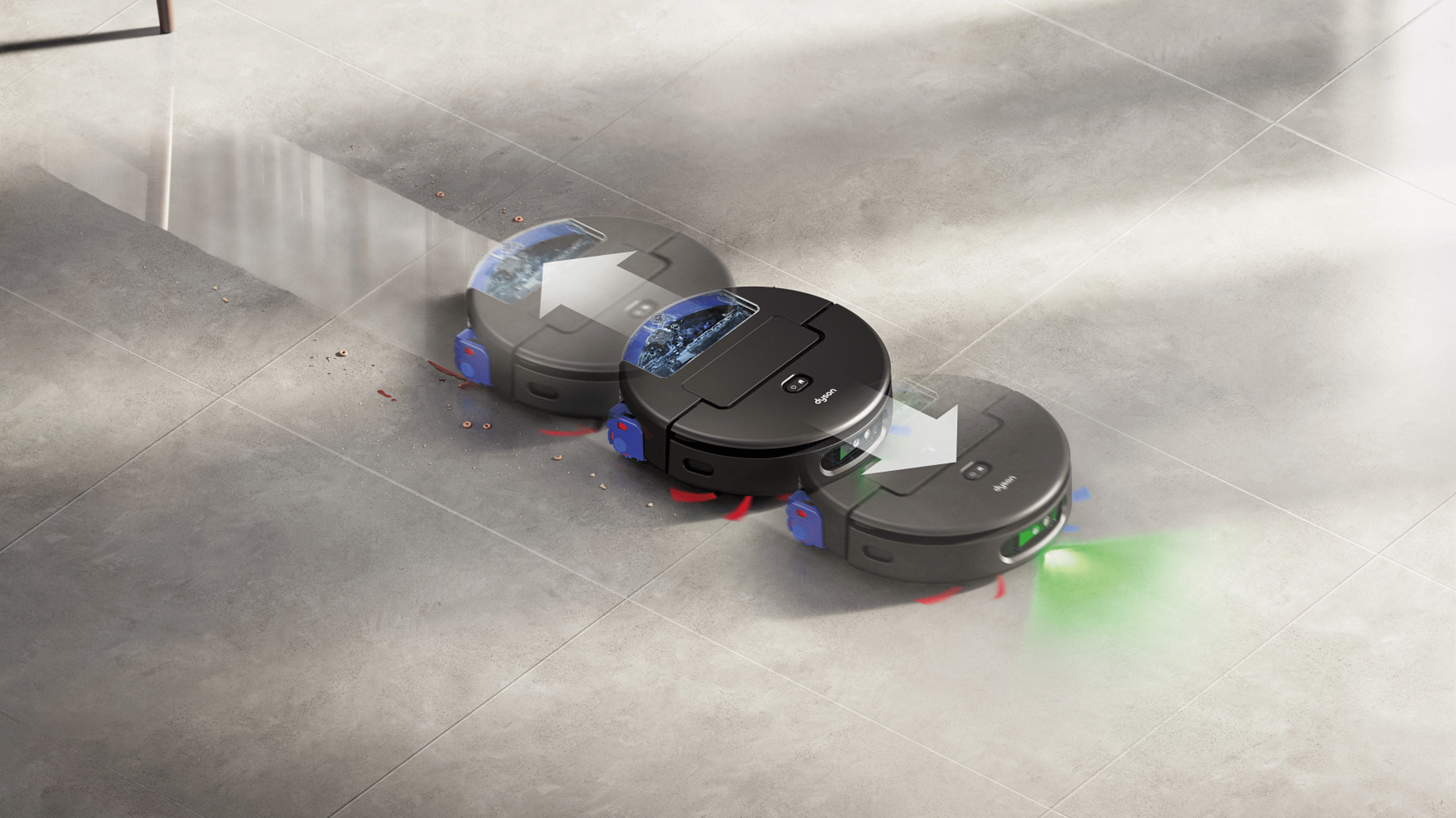 Trois robots Dyson Spot+Scrub Ai nettoient un sol carrelé avec des débris visibles.