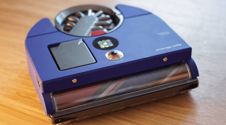 Aspirateur robot Dyson 360 Vis Nav en violet avec un réservoir à poussière transparent.