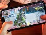 Joueur jouant au jeu Apex Legends Mobile sur iPhone 13.