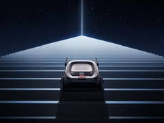 Un eufy MarsRover montant un escalier sous un ciel étoilé avec un faisceau de lumière brillante au-dessus.