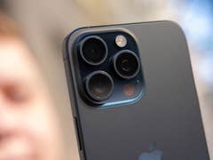 L'iPhone 15 Pro Max d'Apple vu de dos en plein soleil avec un zoom sur son module photo avec ses trois objectifs