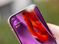 Gros plan d'une main tenant un smartphone Google Pixel 9 Pro affichant la date et la météo.