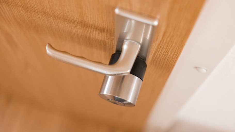 Gros plan du0027une serrure intelligente Nuki Pro montée sur une porte en bois.