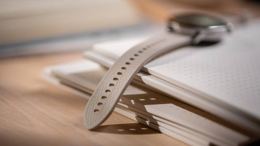 Aperçu rapproché du0027une OnePlus Watch 3 (43 mm) posée sur une pile de notebooks.