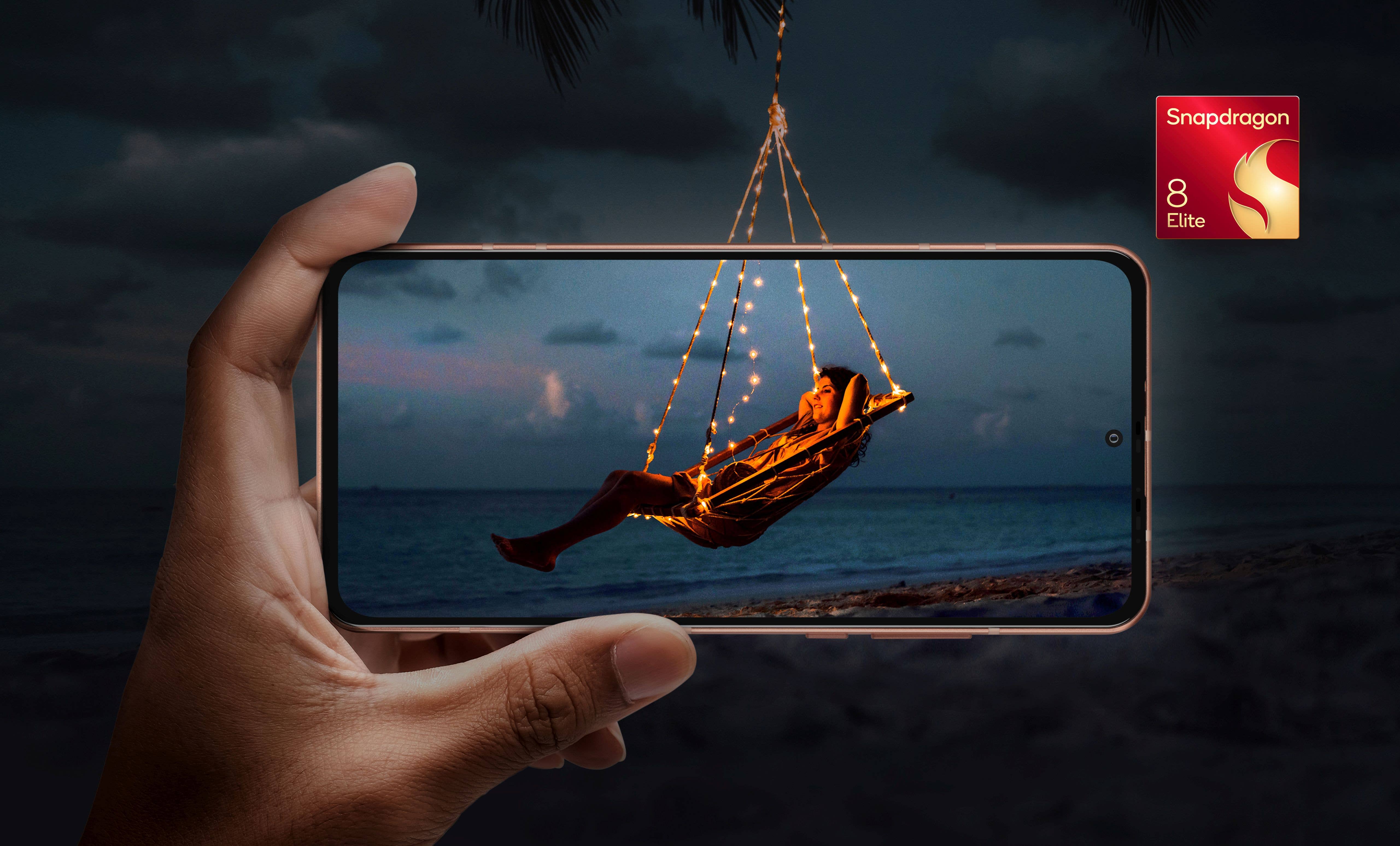 Une main tenant un smartphone affichant une personne se balançant avec des lumières sur une plage la nuit, étiquetée 'Snapdragon 8 Elite'.